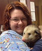 Jess is a pet advocate for PetCure Oncology and she's holding an opossum